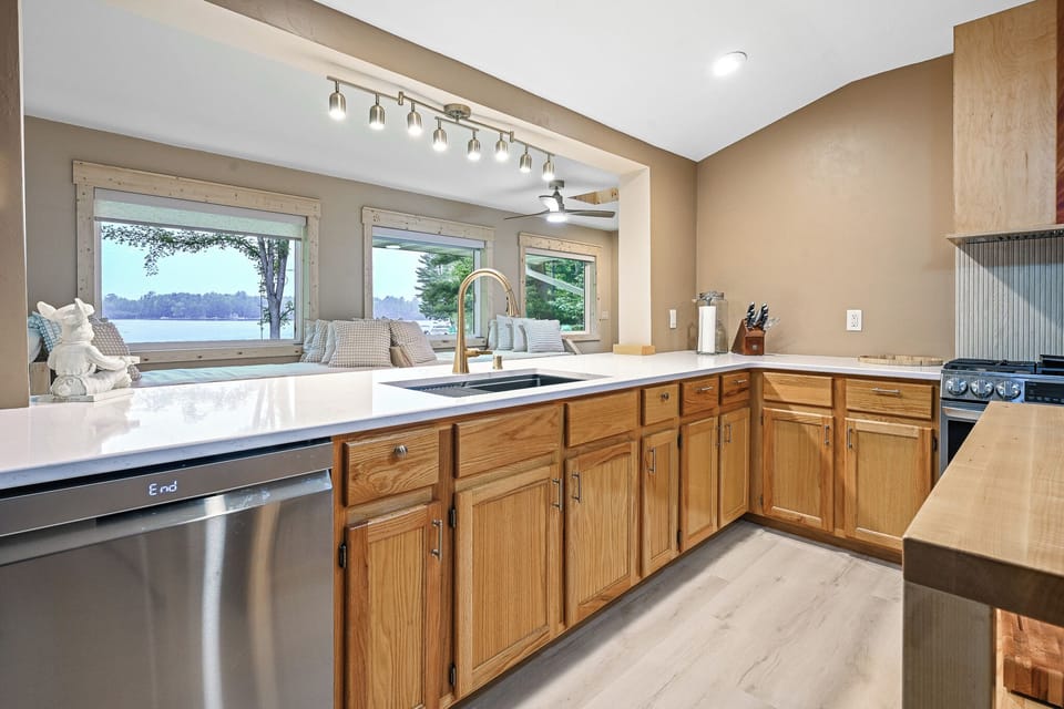 The kitchen is perfectly situated in the center of the upper level.  This allows for meals to be prepared while still allowing you to visit with your family and friends in the dining rooms or on the day beds.  