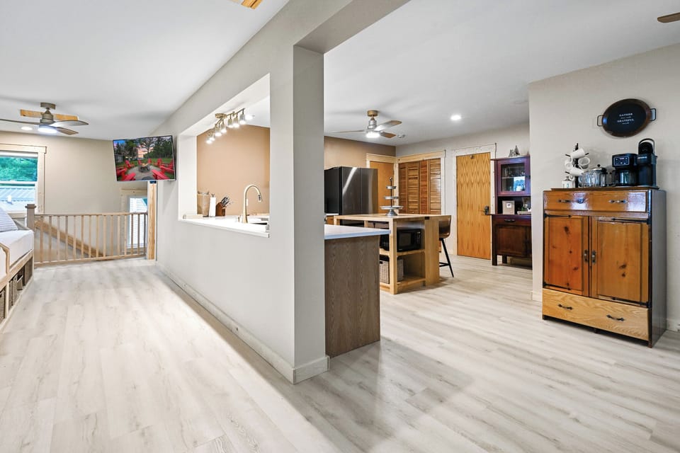 The kitchen is perfectly situated in the center of the upper level.  This allows for meals to be prepared while still allowing you to visit with your family and friends in the dining rooms or on the day beds.  