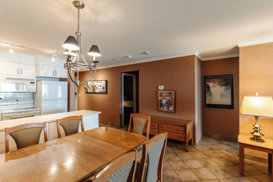 The spacious dining area offers a warm and inviting setting for shared meals, whether enjoying a family dinner, a relaxed breakfast, or gathering after a day by the lake.