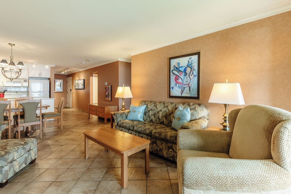 Spacious open-concept living and dining area featuring comfortable seating, warm lighting, and tasteful décor—perfect for relaxing or gathering with family.