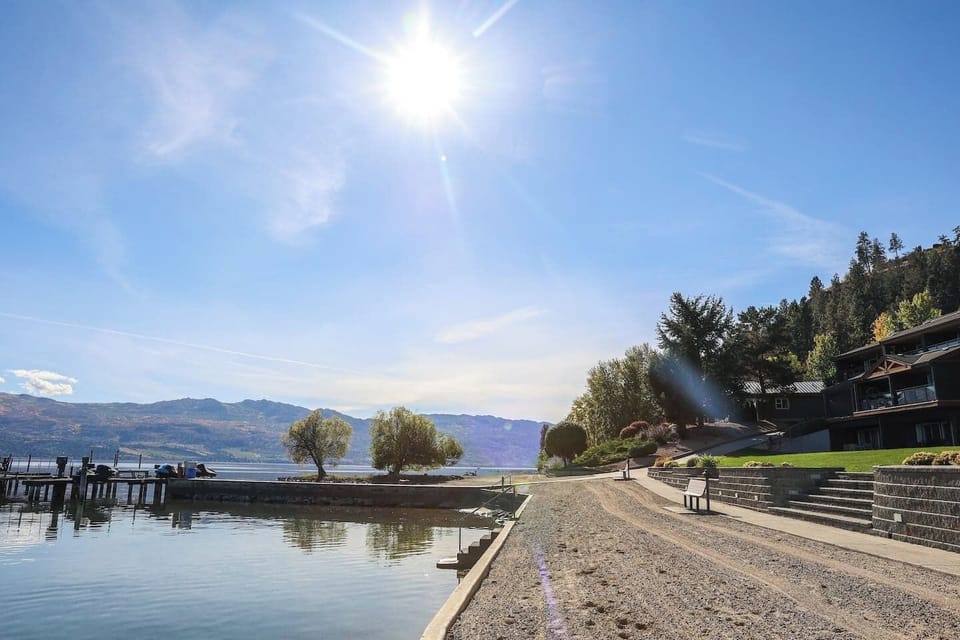 Tranquil lake scene with mountains in the distance, offering a peaceful atmosphere.