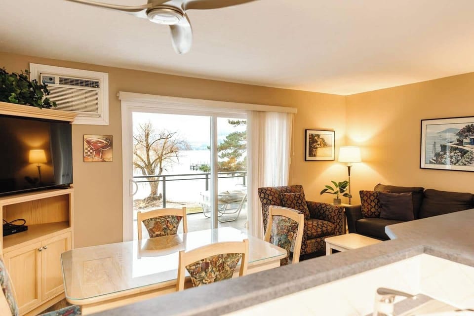 Green siding with warm wooden accents for a cozy, inviting feel.