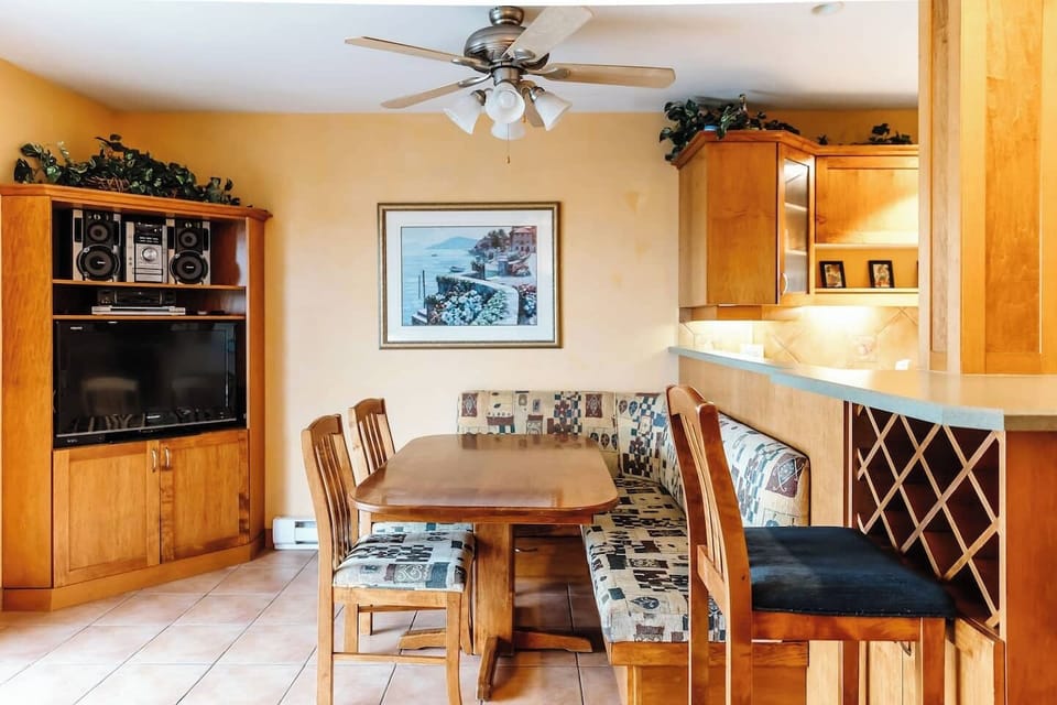 Kitchen with a breakfast bar, two bar stools, and appliances including a stove,and refrigerator