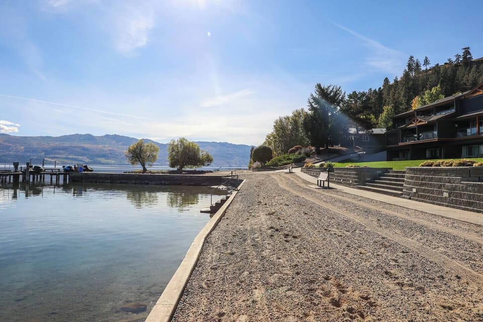 Sandy beach area with a dock and calm water, perfect for relaxation.
