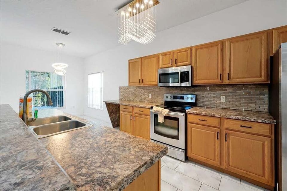 Functional kitchen featuring modern appliances and spacious countertops.