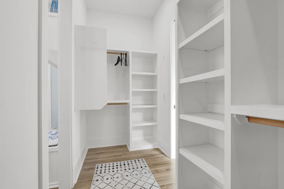 Primary bedroom walk-in closet- Located on main floor - Primary bedroom walk-in closet- Located on main floor