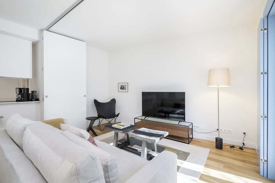 Spacious living room with a comfortable sofa, smart TV, and a design entertainment unit. A great natural light enhances the cozy, modern ambiance.
