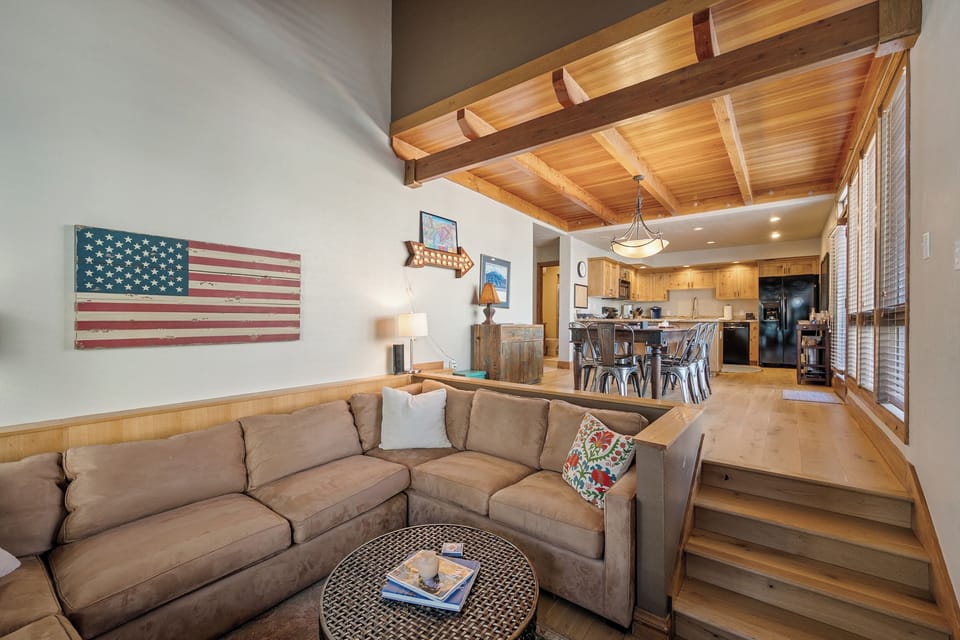 Sink into this plush sectional and admire the rustic wood beams overhead while your open kitchen awaits your culinary adventures.