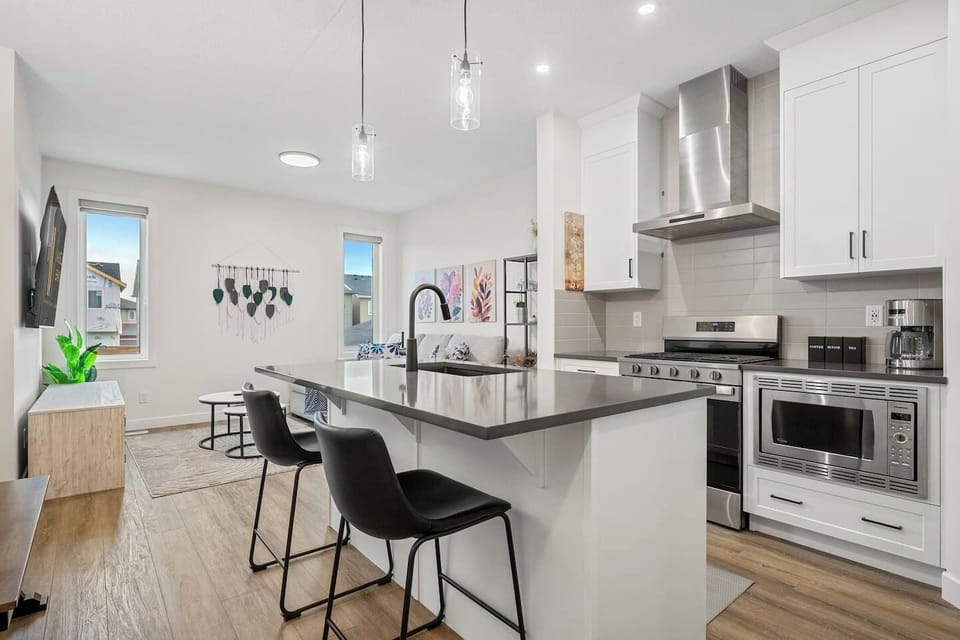 Main floor`s full kitchen with a drip coffee maker, ground coffee, tea, sugar, basic condiments (ketchup, mustard, relish), and an air fryer.