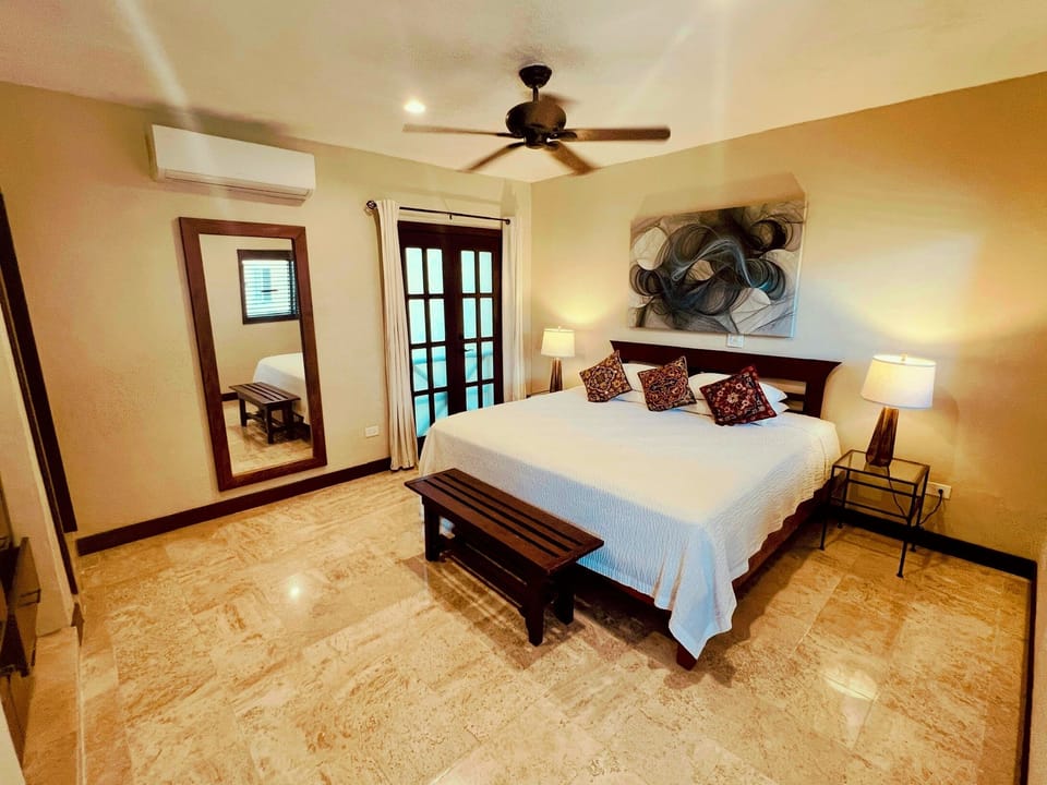 Inviting bedroom suite with a king bed, abstract art, and warm lighting.