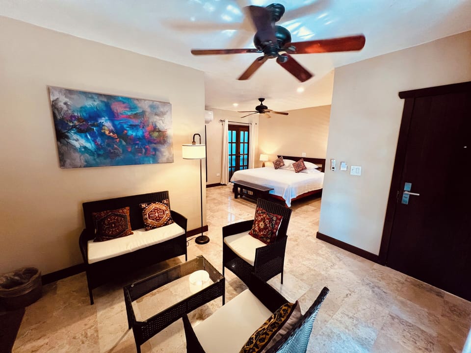 Luxury suite with an open-concept layout, king bedroom, and cozy sitting area.