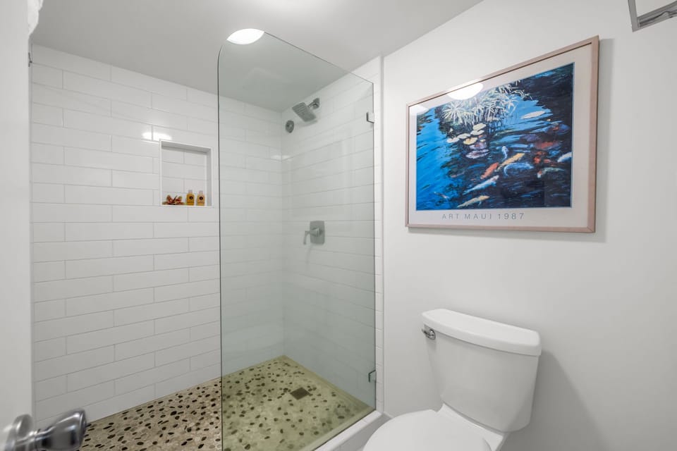 Refreshing bathroom with a walk‑in shower and clean tile finishes offers a bright, spa‑like retreat.