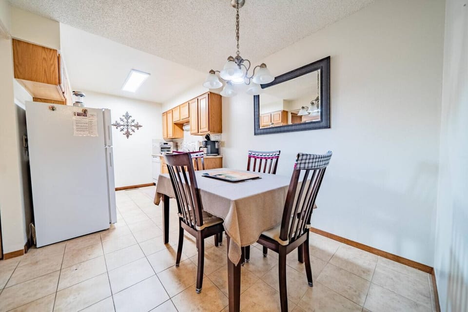 Kitchen and dining area with a table that seats 4
