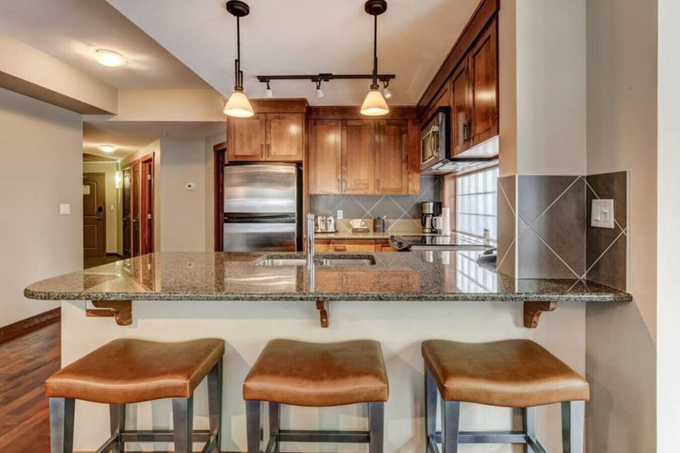 well-stocked kitchen with breakfast bar.