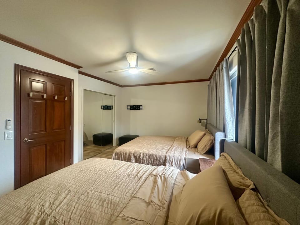 Bright bedroom with modern ceiling fan and clean design.