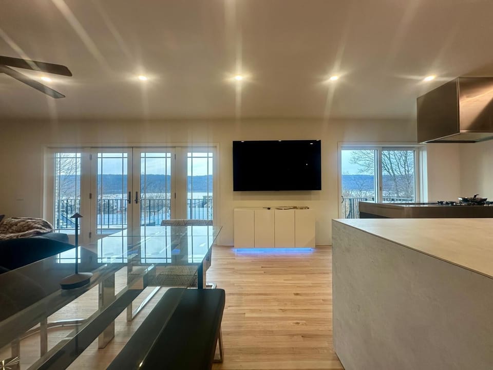 Spacious open-plan living area with large windows.