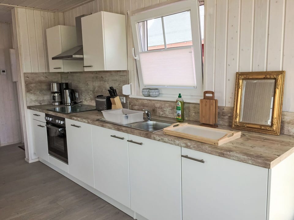 Flooring, Wood, Countertop, Floor, Kitchen, Interior Design, Cabinetry, Furniture, Plumbing Fixture, Kitchen Sink