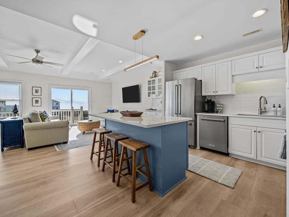Your bright open-plan kitchen flows seamlessly into the living space, perfect for vacation cooking and relaxing together.