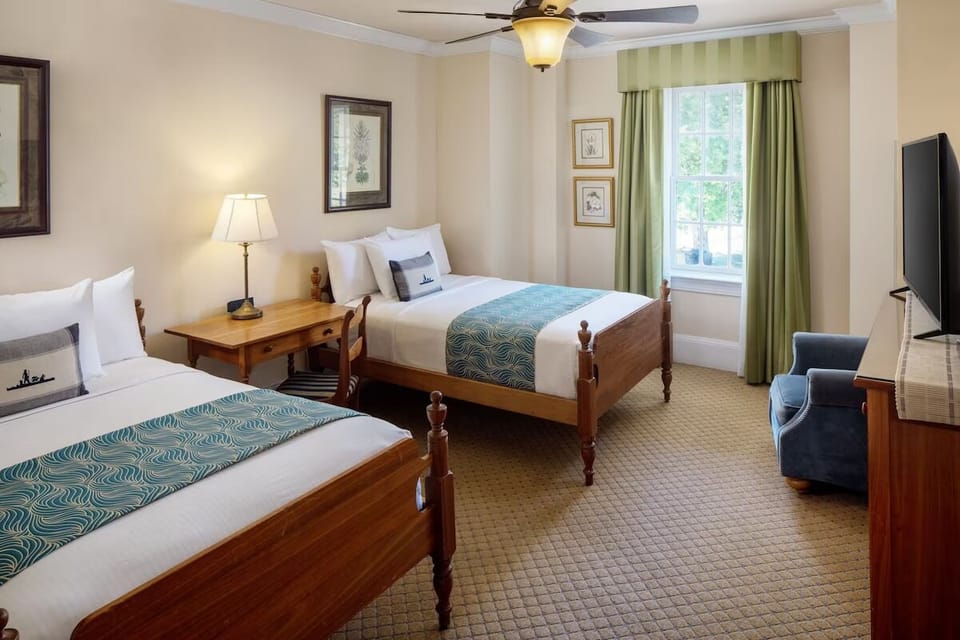 Unwind in cozy twin beds with soft linens and warm light.