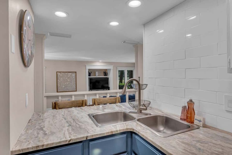 Your modern kitchen features marble countertops, stainless steel double sink, and subway tile backsplash for effortless meal prep.