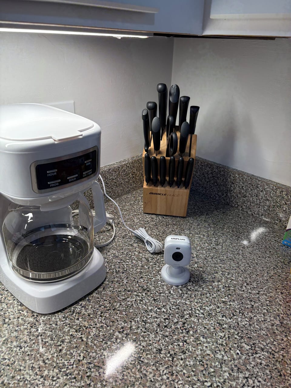 Camera 1, on Kitchen counter facing front door, UNPLUG during arrival.