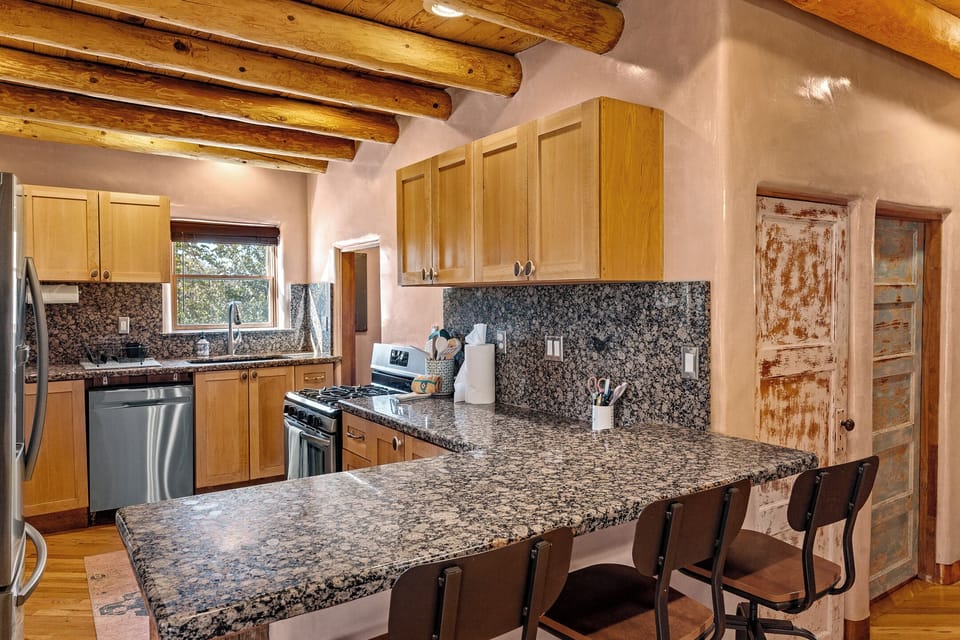 Kitchen with bar seating, fully stocked for cooking and entertaining!