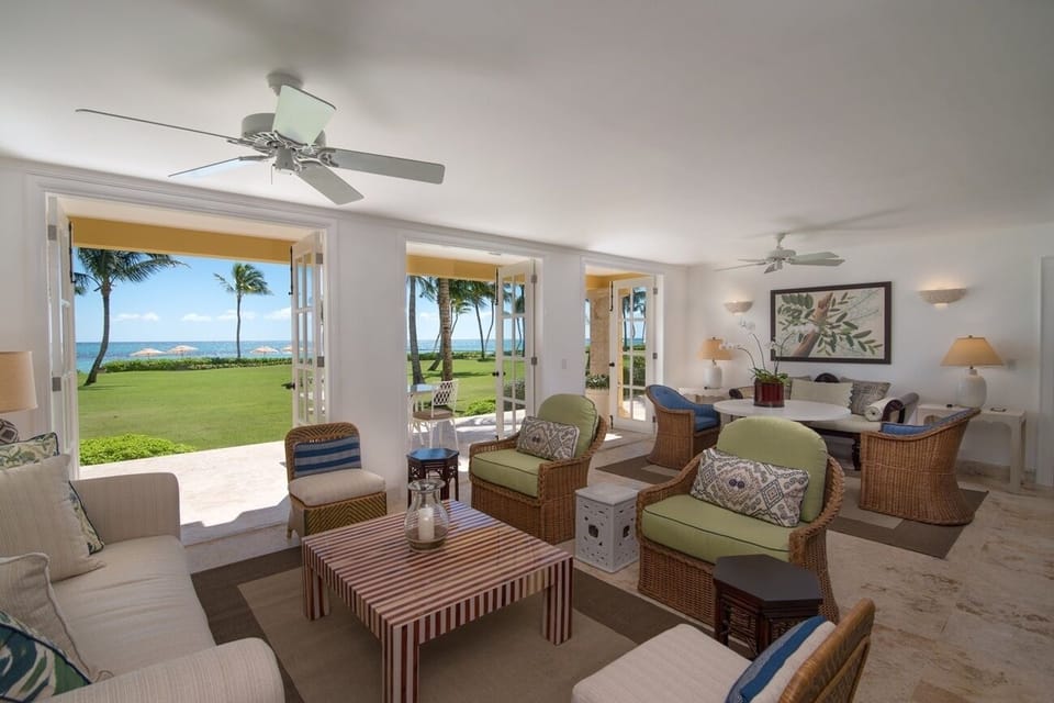 Linger over cocktails with wide-open lawn and ocean views.
