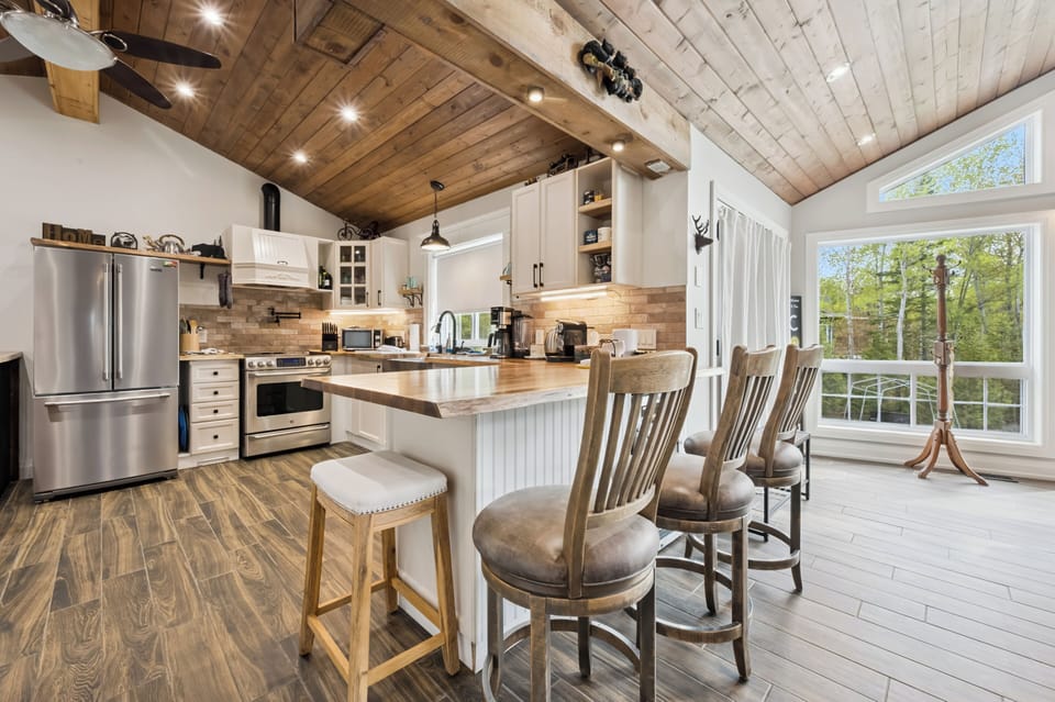 Cozy rustic peninsula seating faces the kitchen and dining area, creating the perfect gathering spot. Oversized, ultra-comfortable island chairs invite you to relax, connect, and enjoy everyday moments with family and friends.