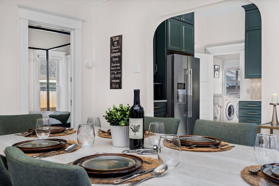 Gather around this elegant dining table for memorable meals, with a fully equipped kitchen and convenient laundry facilities nearby.