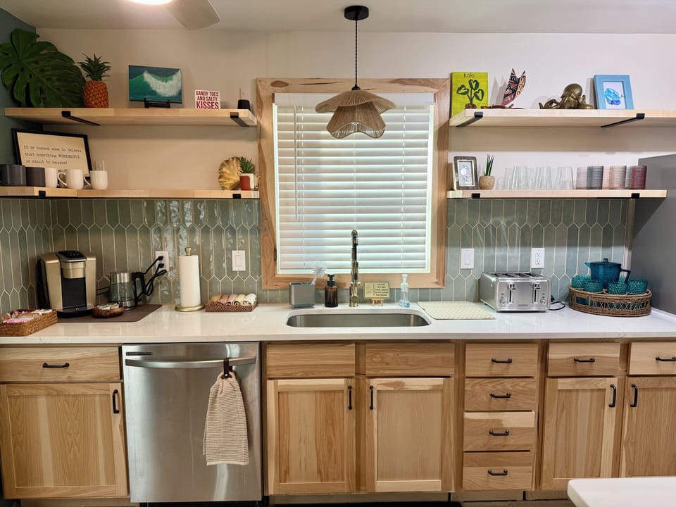 Kitchen also includes a deep sink and a full-size dishwasher for easy cleanup.