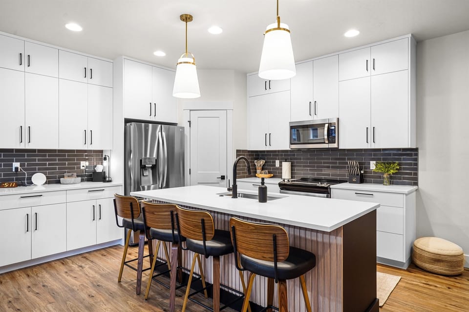Gather around the large island in this beautiful modern kitchen area