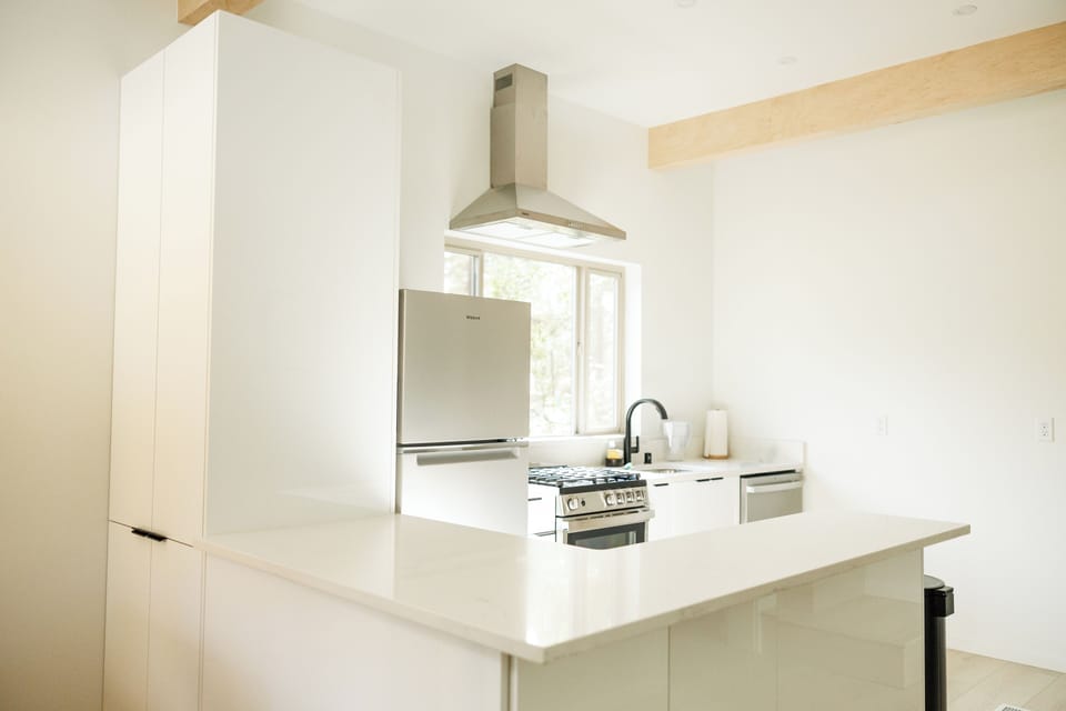Premium quartz countertops and modern, high-quality cabinetry define the kitchen