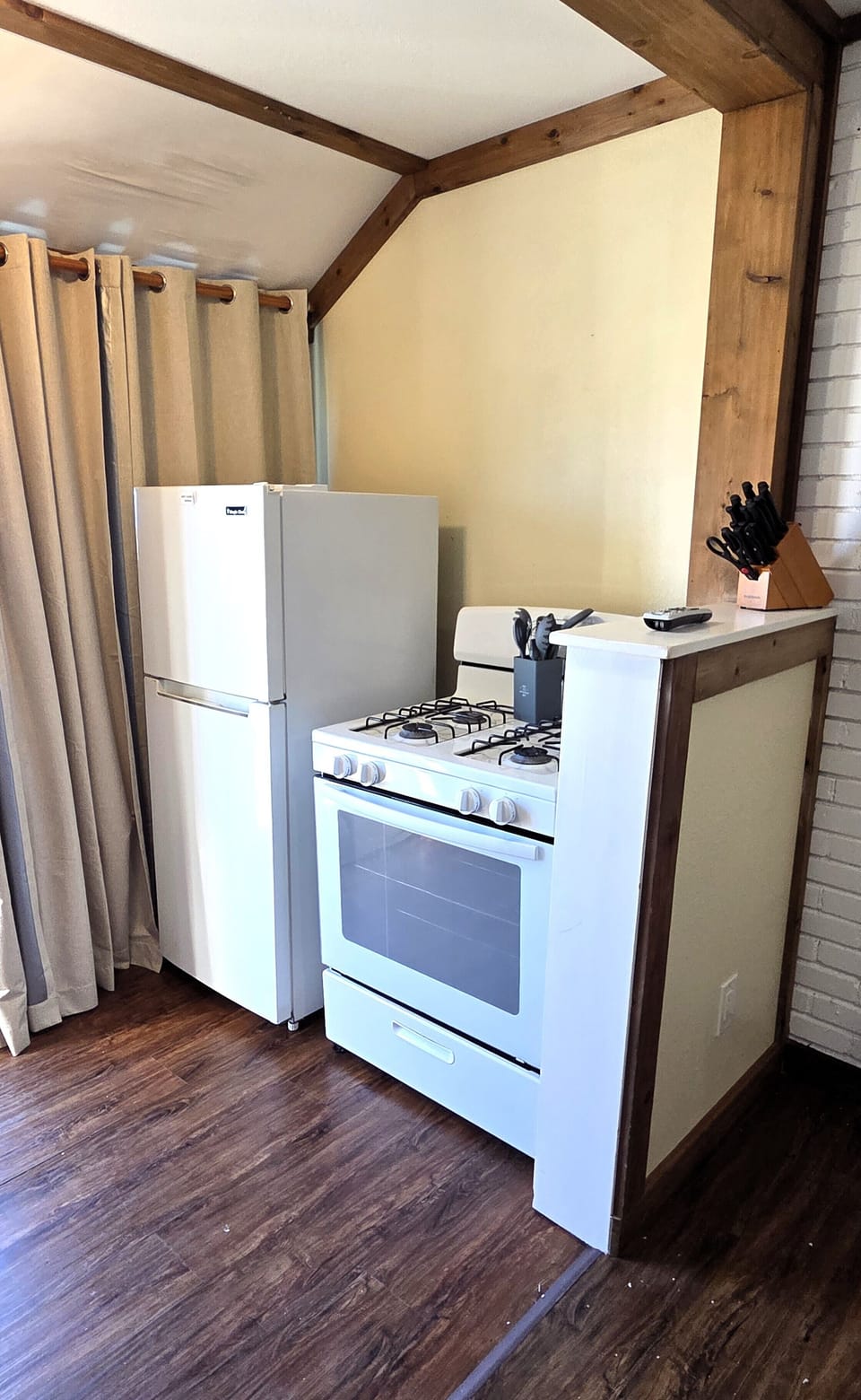 The kitchen has gas appliances and a refrigerator/freezer