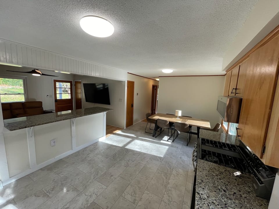 Open kitchen and dining space near Downtown Brevard & Pisgah Forest trails.