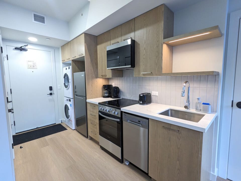 Private suite kitchenette with dishwasher, oven, microwave, and fridge — ideal for extended stays or families wanting privacy.