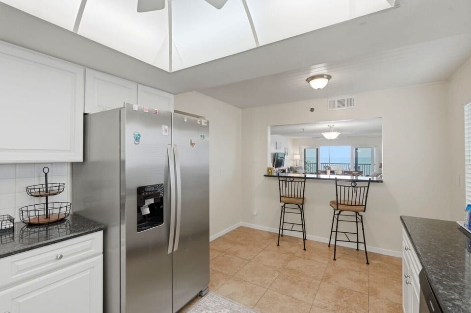 Stainless refrigerator and breakfast bar seating