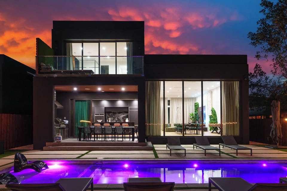 Luxury modern home exterior with ambient lighting and sleek architectural design