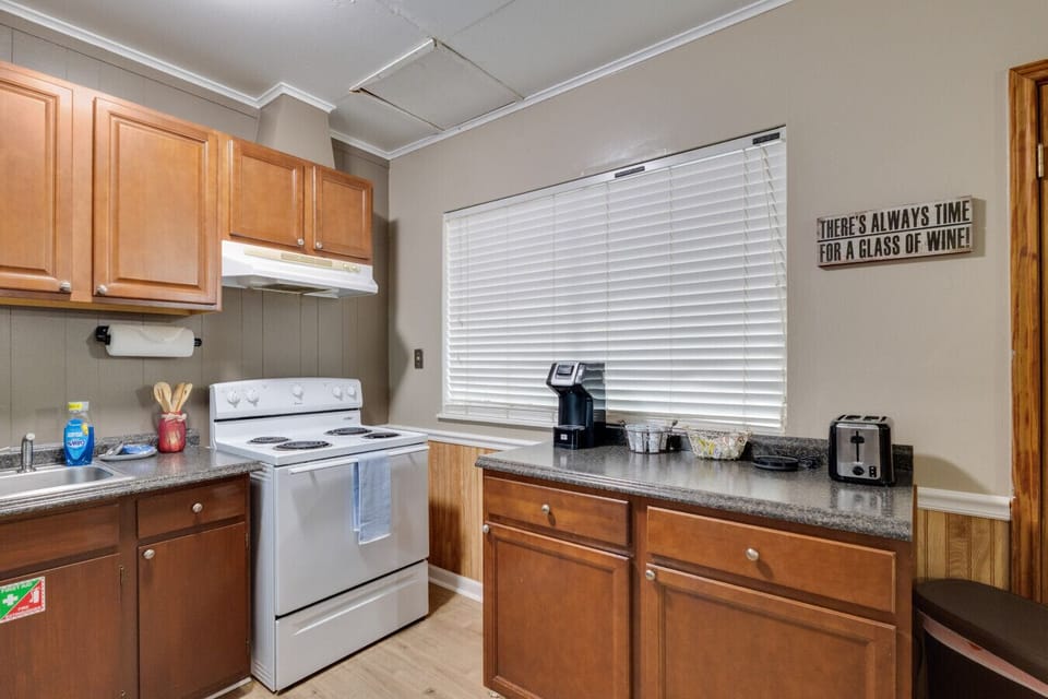 K-cup coffee maker, toaster, and four burner electric stove with oven.