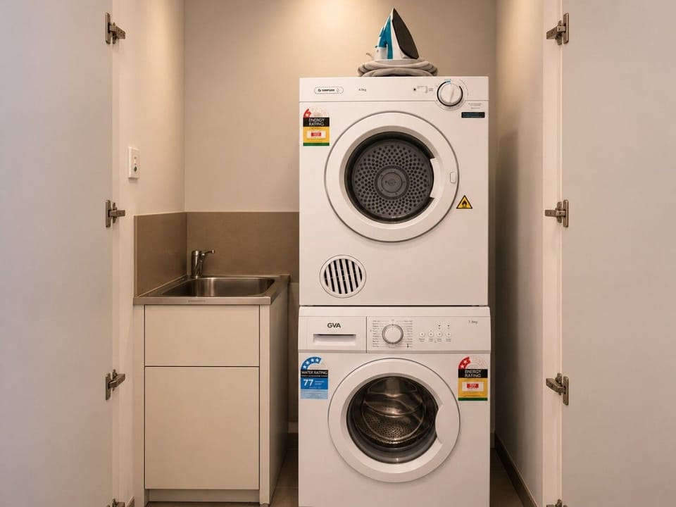The in-unit laundry is equipped with both a washing machine and dryer.