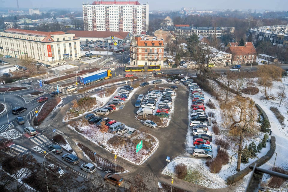 City view from above with nearby buildings and roads.