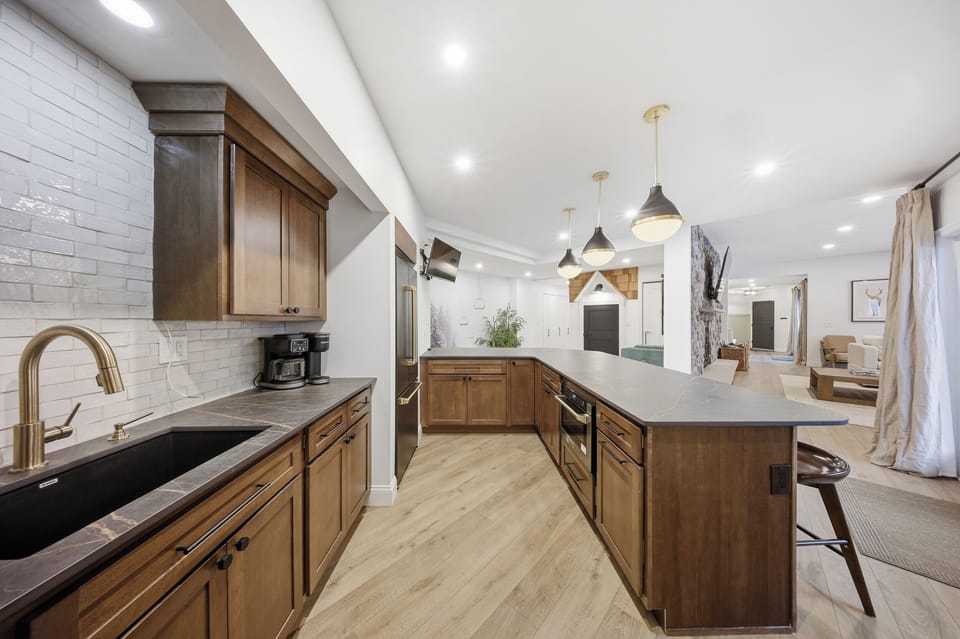 Lower-level wet bar by hot tub & playhouse—relax while kids play