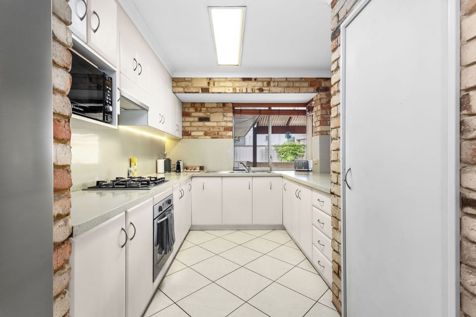 Fully equipped kitchen with gas stove, microwave, oven, coffee machine and toaster