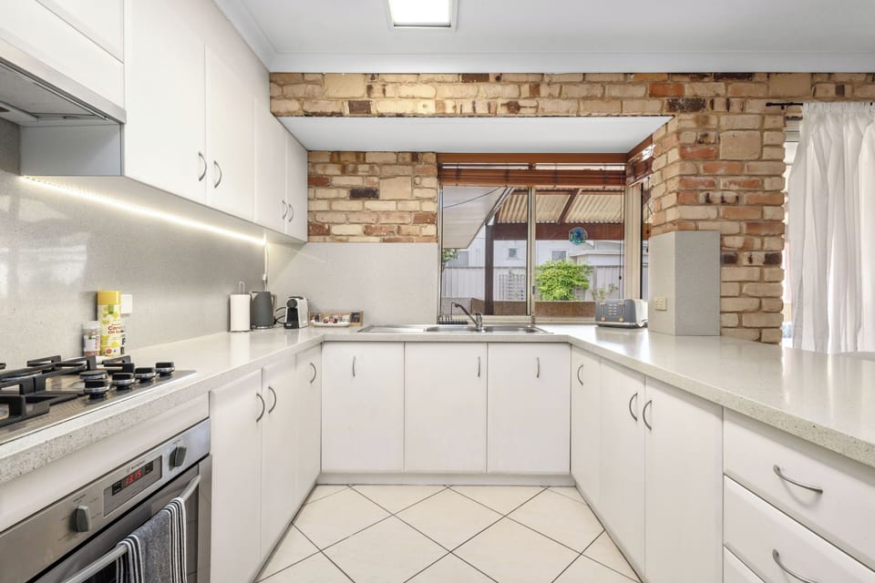 Fully equipped kitchen with gas stove, microwave, oven, coffee machine and toaster