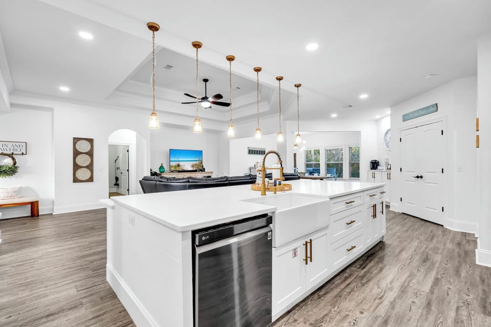 Your spacious kitchen invites culinary adventures with gleaming countertops, premium appliances, and elegant pendant lighting creating the perfect gathering space.