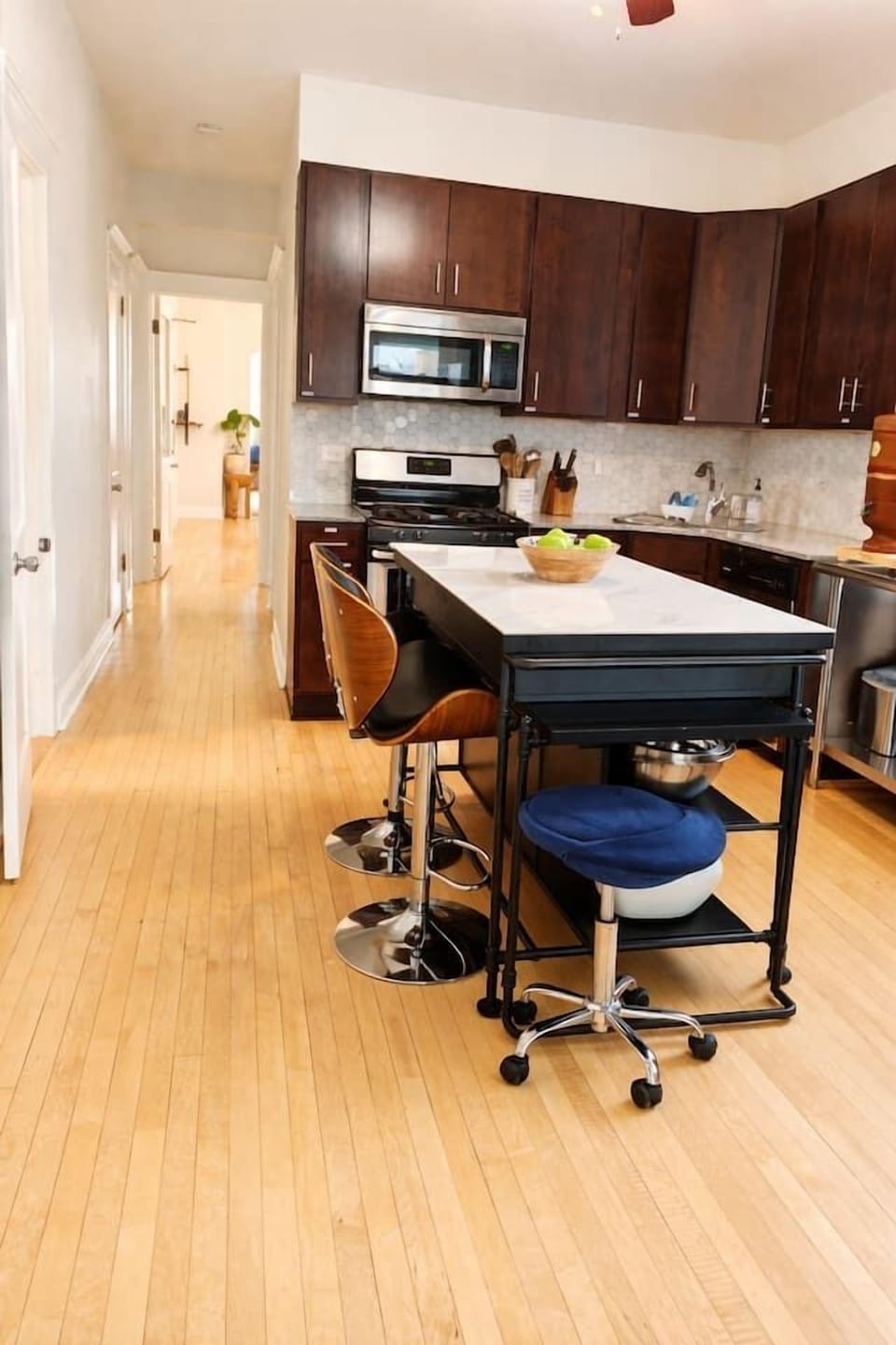 Kitchen island with bar seating fully stocked for cooking amazing meals.