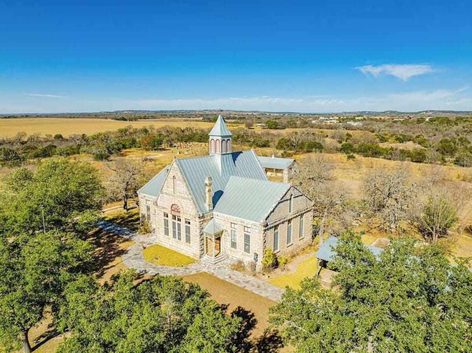 An entire compound, the Schoolhouse featured here lies in the heart of the 10-acre property. Used for it's dining room, living room, and bar, the Schoolhouse is a perfect place for your guests to gather. Note that this building doesn't have bedrooms.