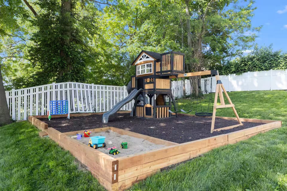 Gazebo, fully fenced yard with a modern swing set, clubhouse, sandbox & mulch