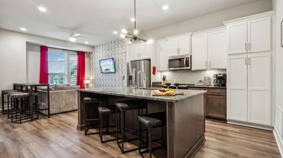 The kitchen island becomes your cocktail station and command center, with plenty of bar seating and an open flow straight into the living area so nobody's left out of the action