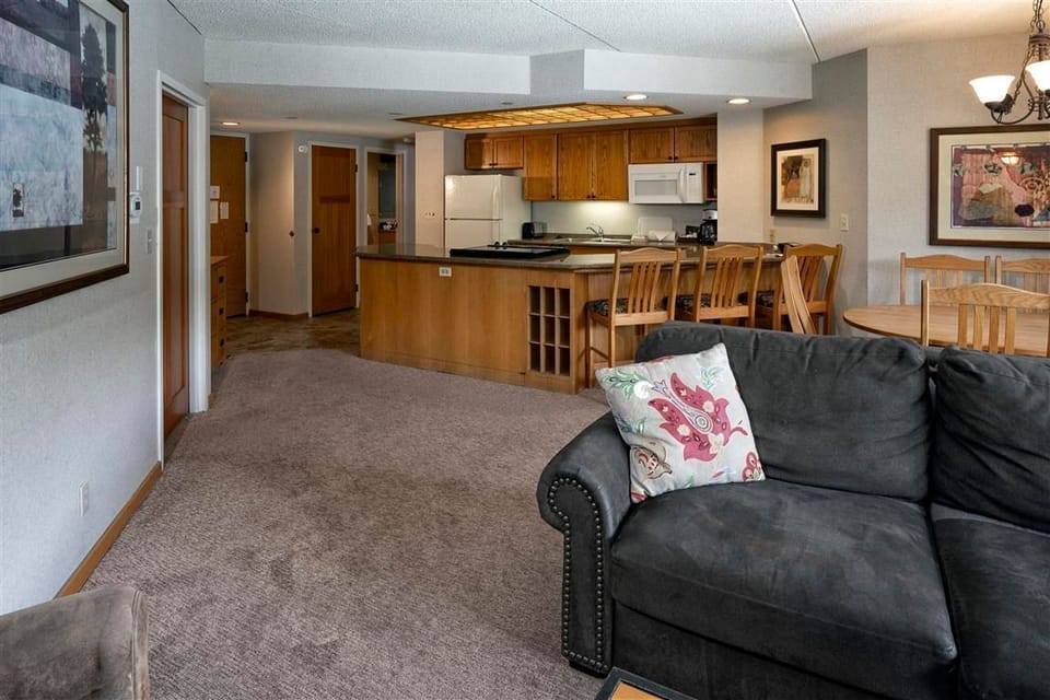 Spacious open-plan living area with kitchen and dining for family gatherings.