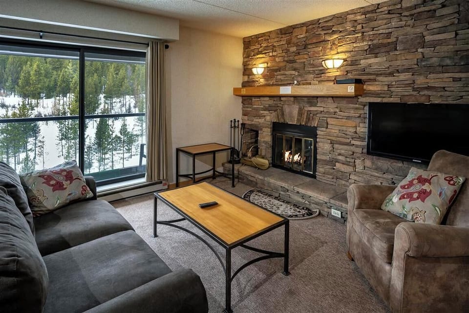 Relax by the cozy fireplace with mountain views just outside your balcony.
